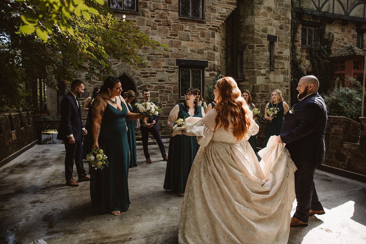A person in a wedding dress talking with their wedding party 