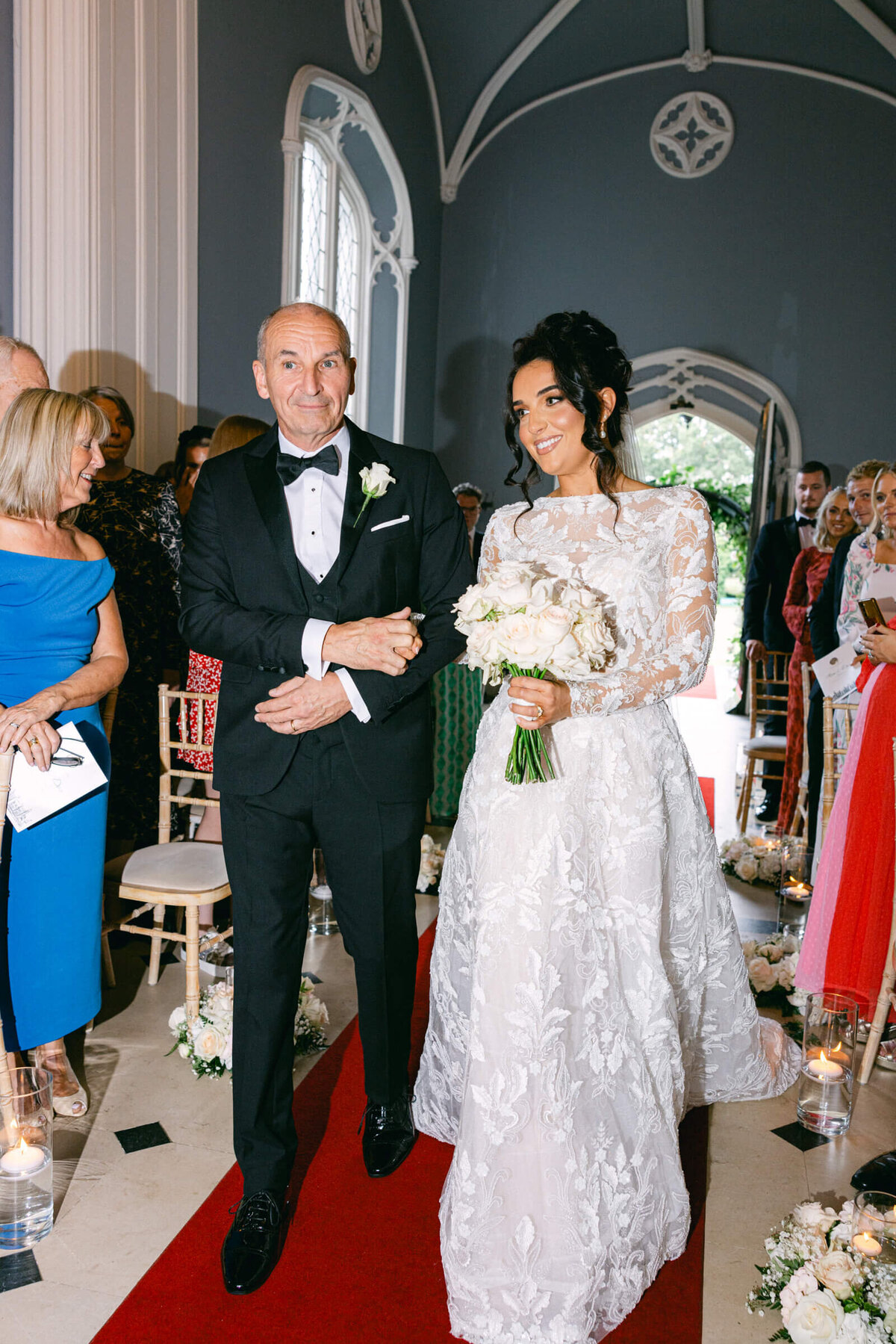 A wedding photo of the bride walking down the aisle