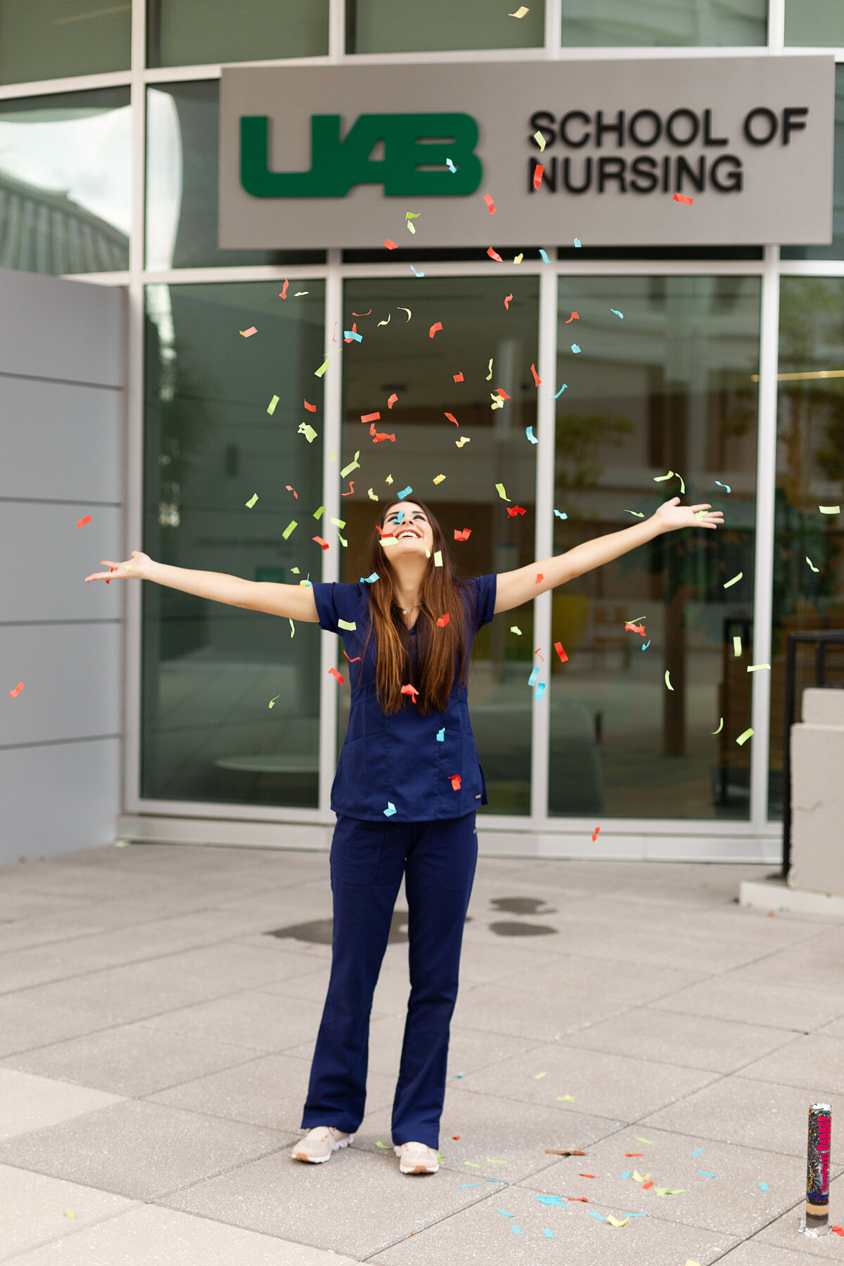 Noel throws confetti for her nursing grad session in Birmingham, AL.