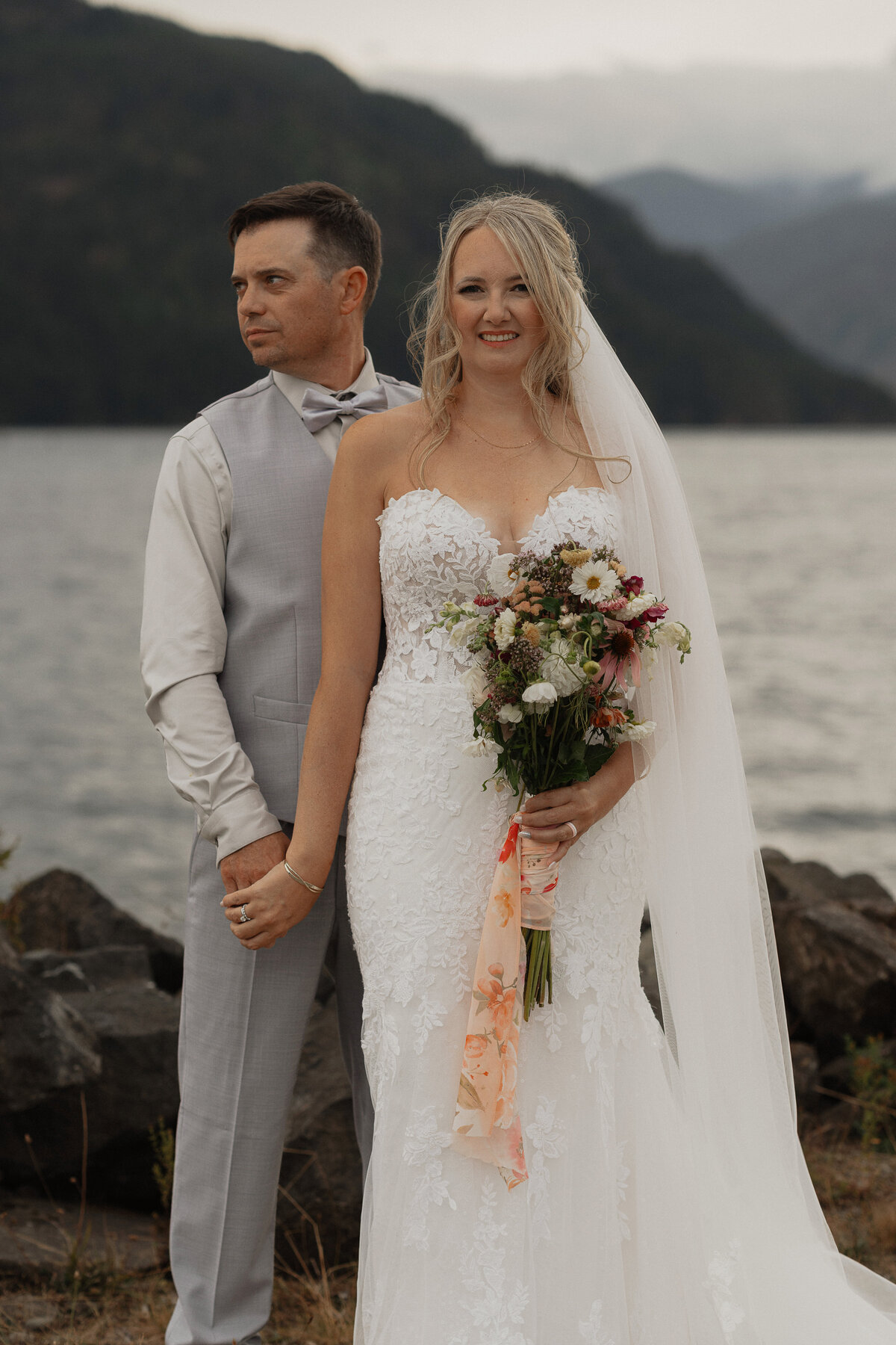 Bride and groom at comox lake at the fish and game club during their wedding portraits by latitude 49 photography