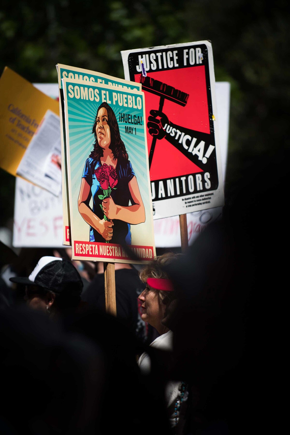 Signs are held "Somos El Pueblo" at AFT rally