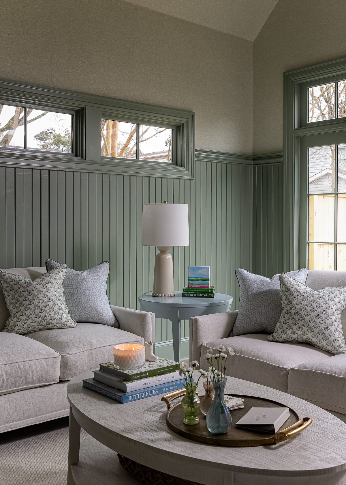 melinda chesson interiors carriage house living room with whtie couches and lamp on sidetable