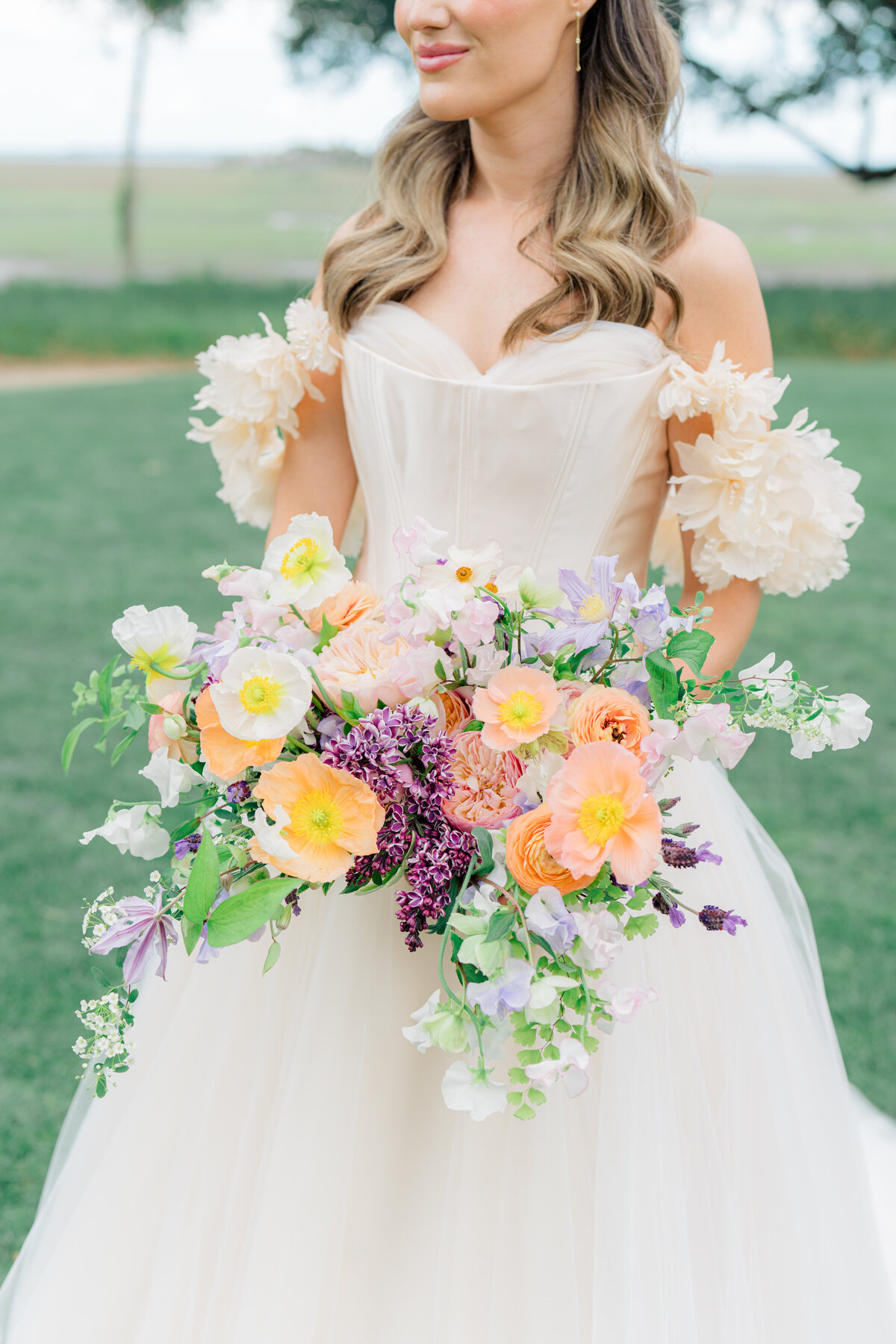 Peach, pink, and purple  wedding flowers. Blush Wedding dress with floral sleeves