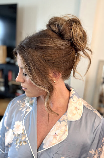 messy high bun bridesmaid hairstyle