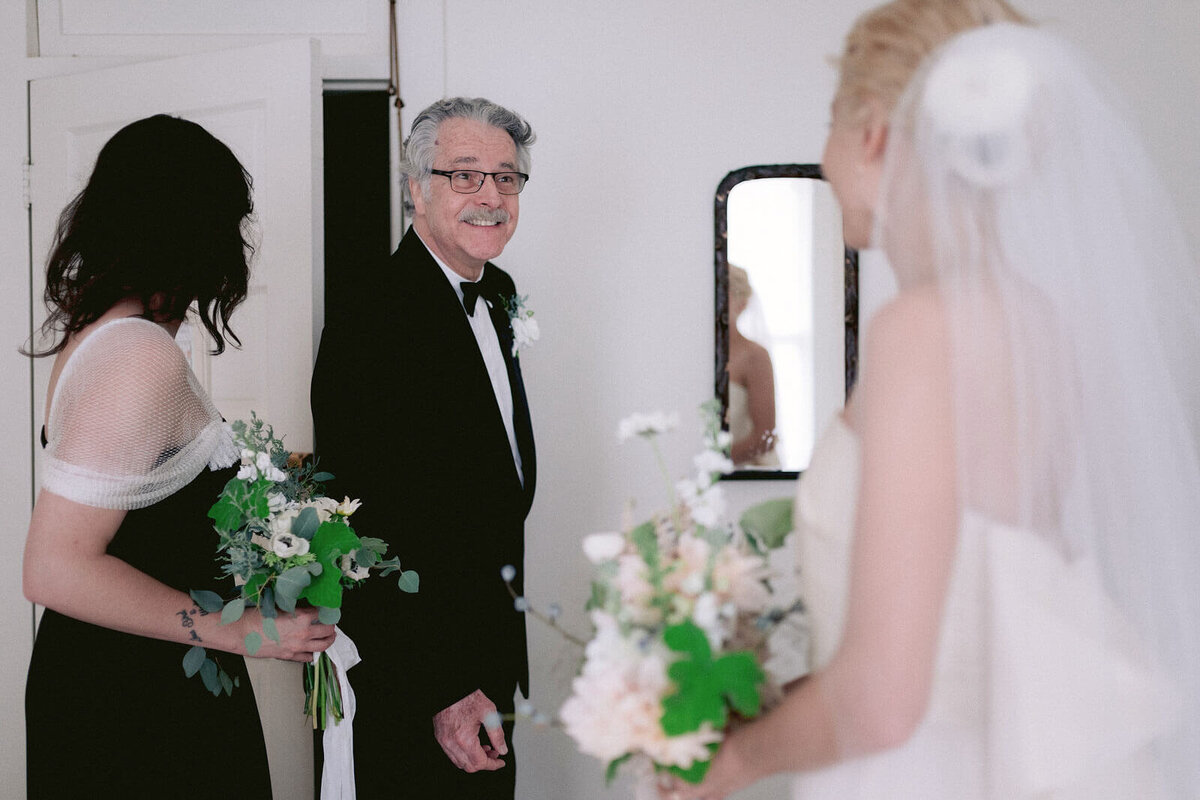 The bride is talking to her father before the ceremony in Foxfire Mountain House, New York. Wedding Image by Jenny Fu Studio