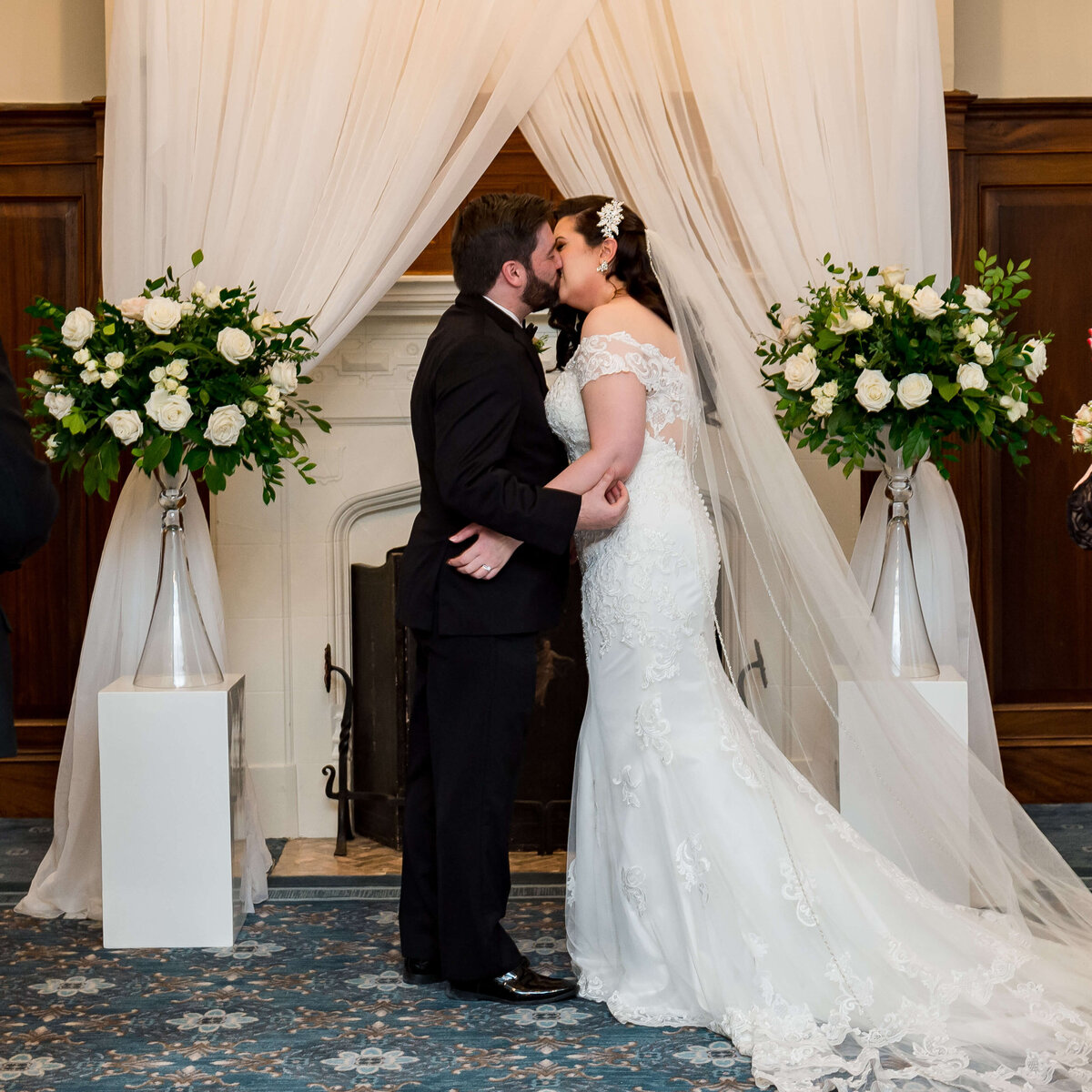a bride and groom kiss in front of the fireplace in the Chateau Laurier during their Ottawa wedding photography