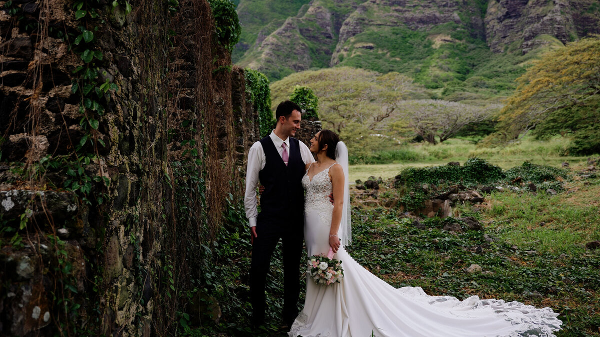 Bride and groom pose for a wedding portrait in a natural landscape