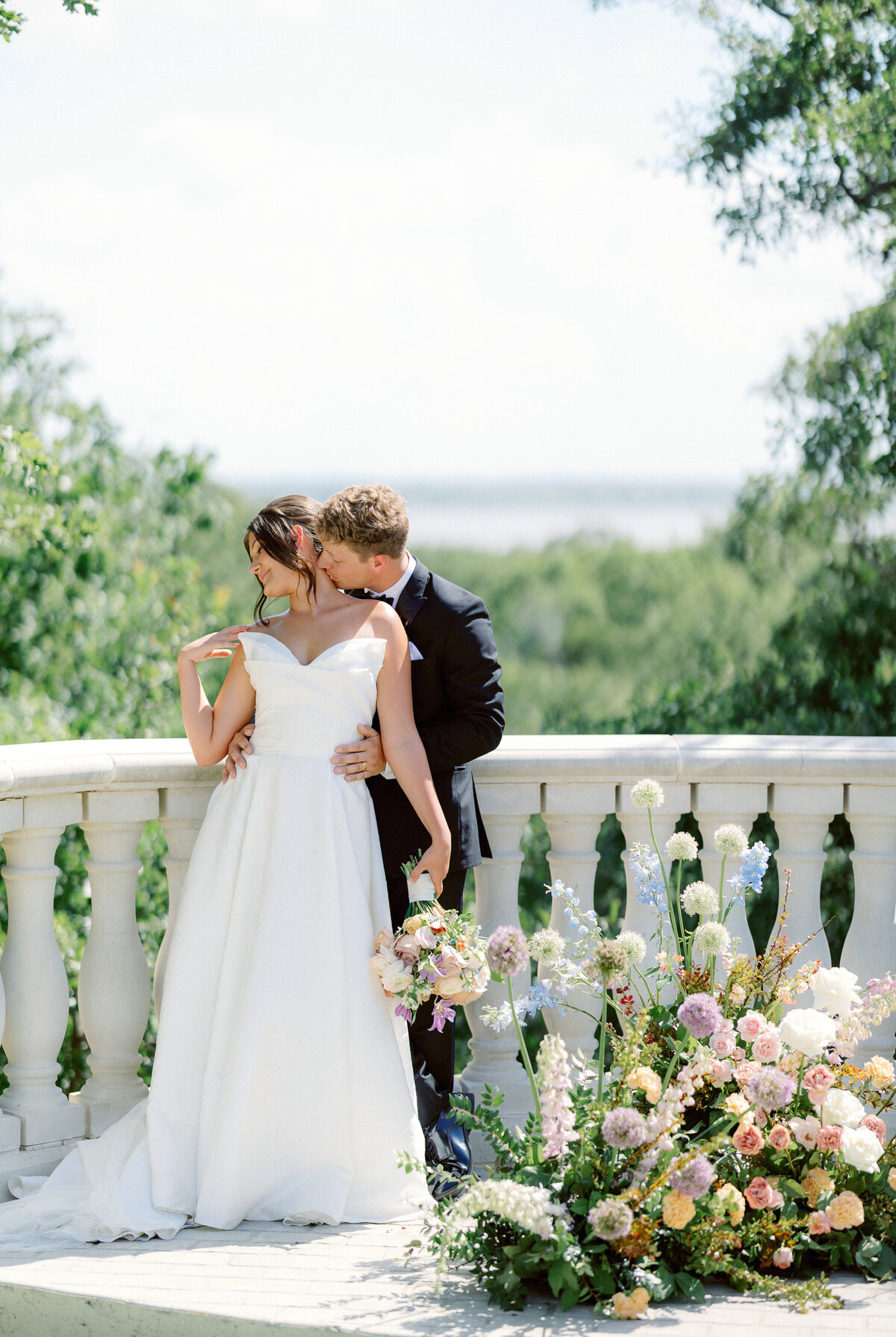 Couple kisses by balcony