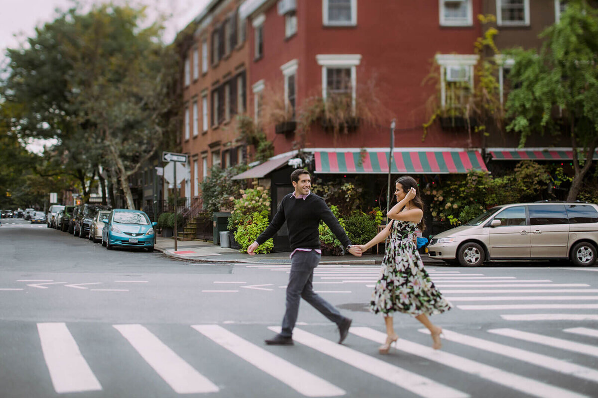 The engaged couple is happily crossing the pedestrian lane in West Village, Manhattan, NYC. Image by Jenny Fu Studio.