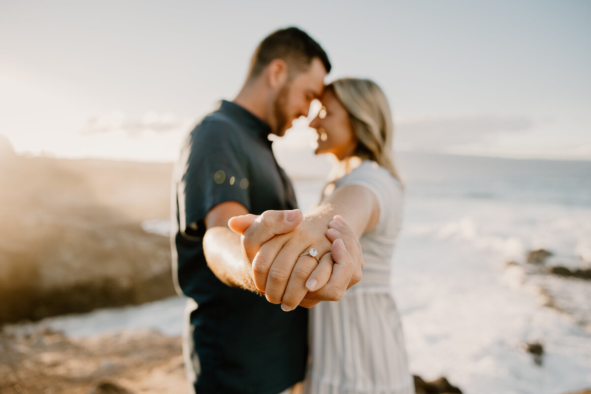 Hawaii Engagement Photographer captures man and woman holding hands on beach