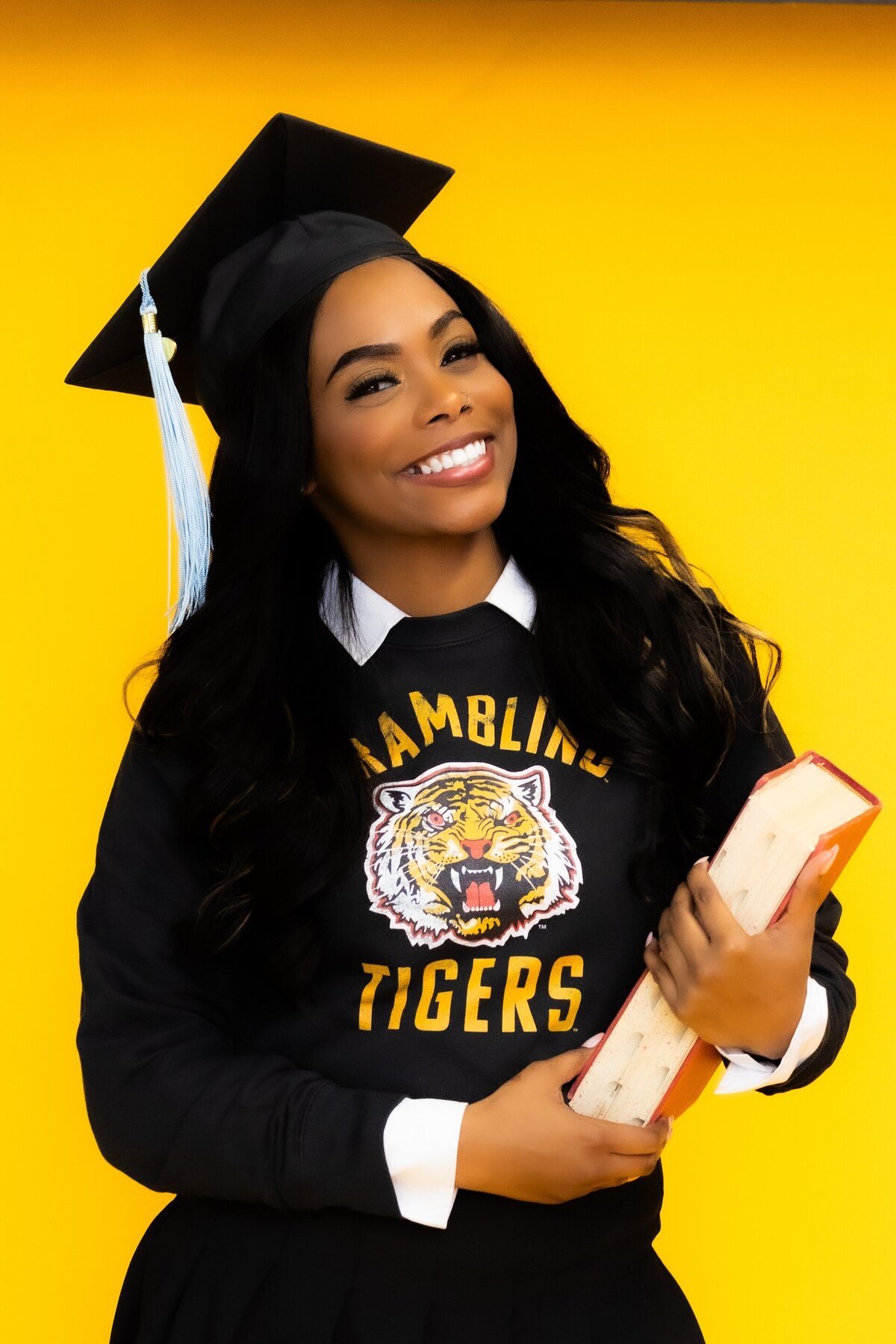 a college graduate wearing a sweatshirt with her school mascot
