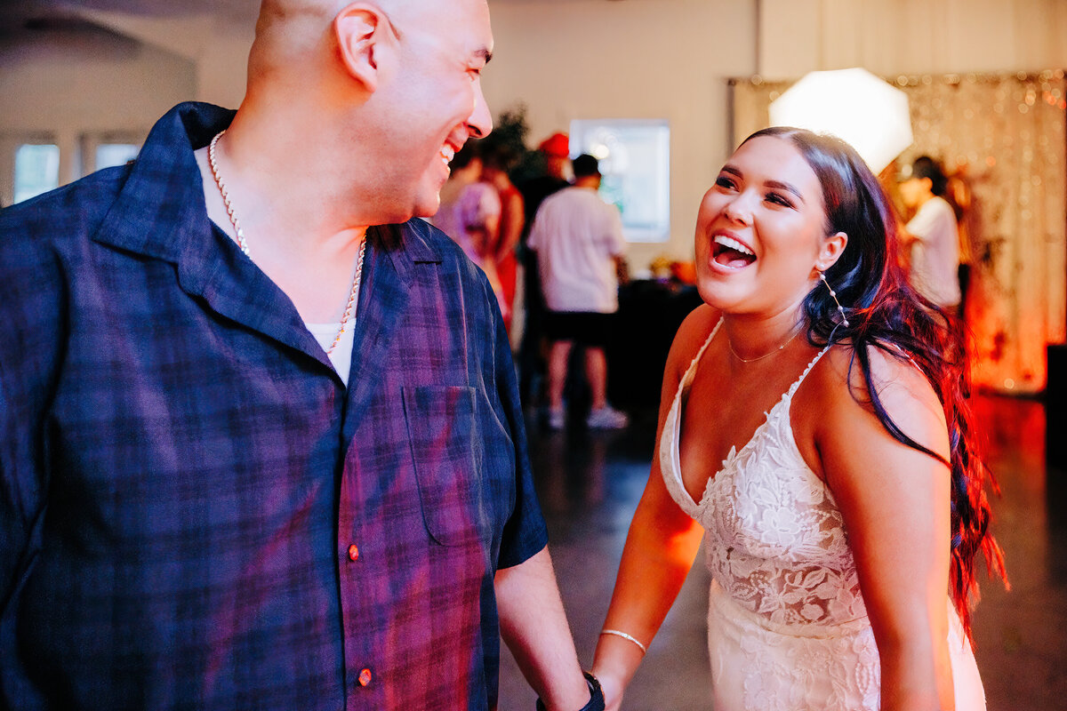 Bride-laughing-guest-wedding-reception-Chancey's-Event-Center