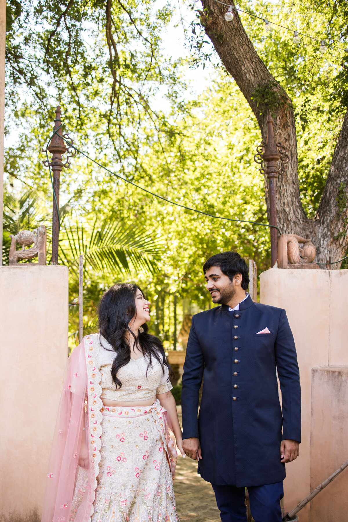 Couple smiling and holding hands in traditional attire