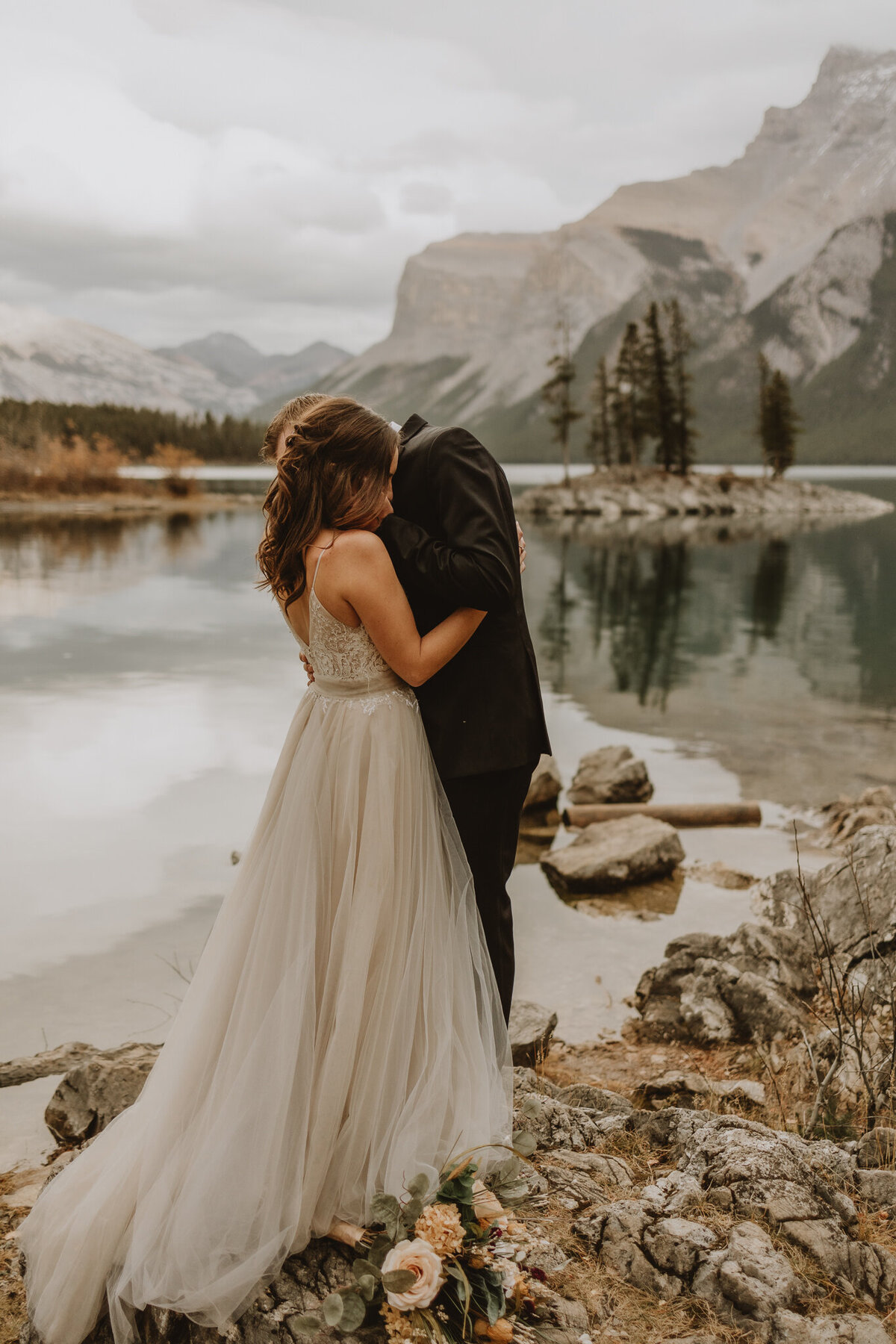 Bride and groom hugging in Banff, Alberta