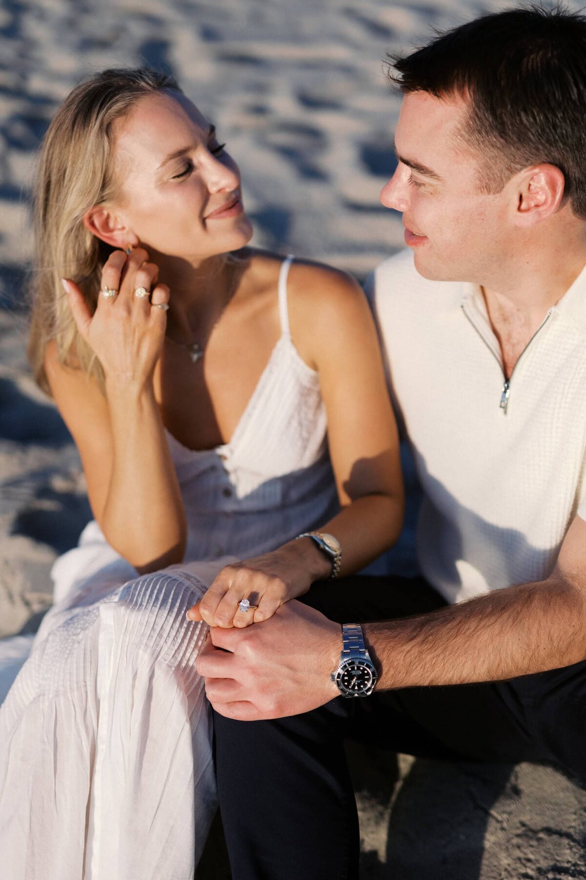 couple looking at one another during golden hour at the beach in southampton