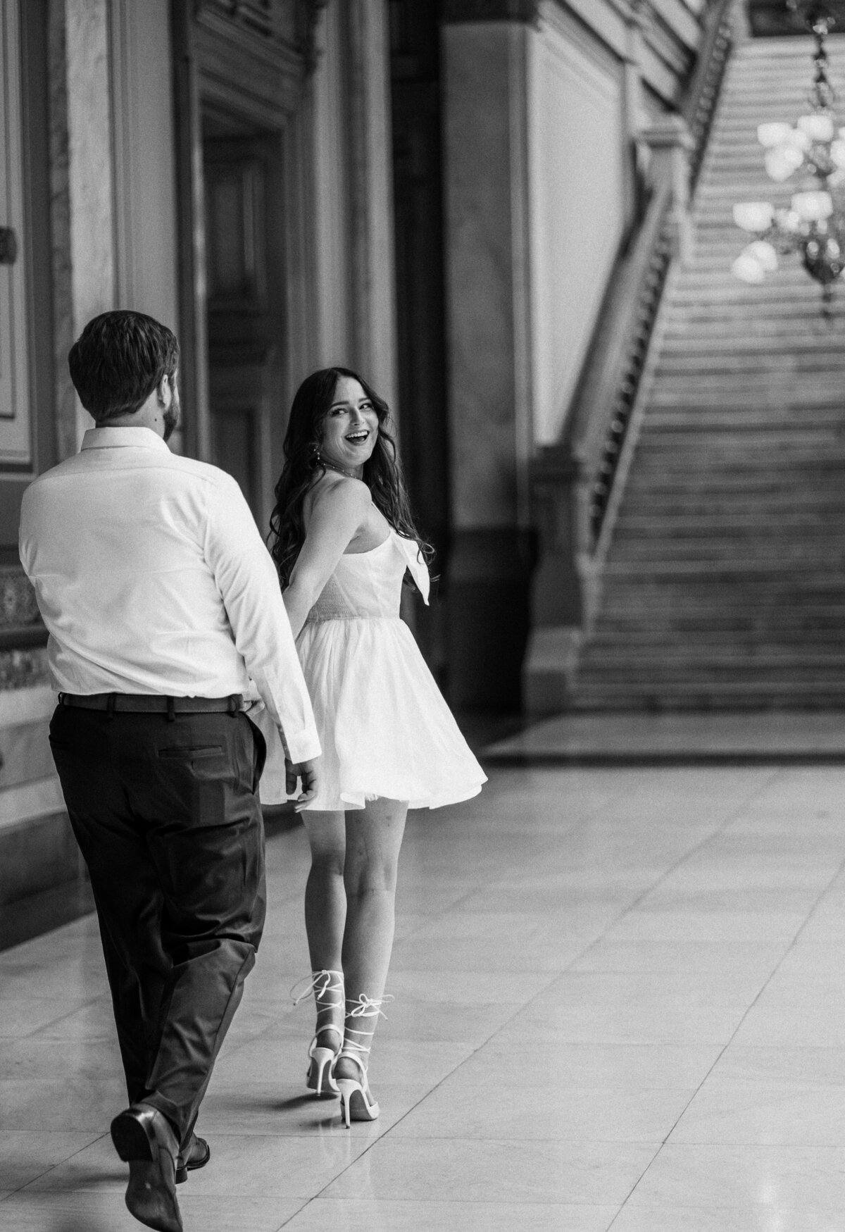 bride getting ready infront of a mirror in the bathroom at wedding venue