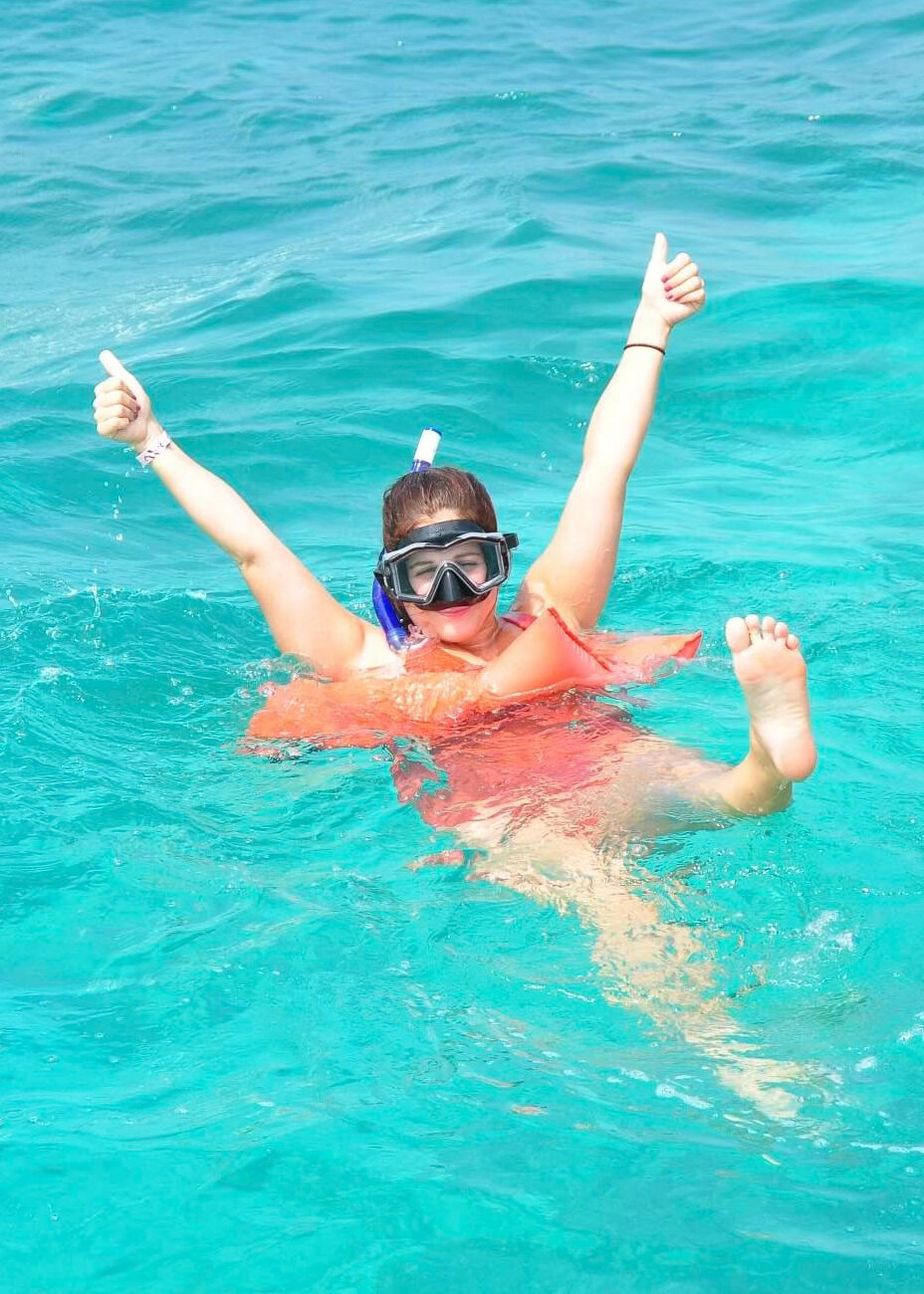 Woman swimming in the ocean wearing a snorkel