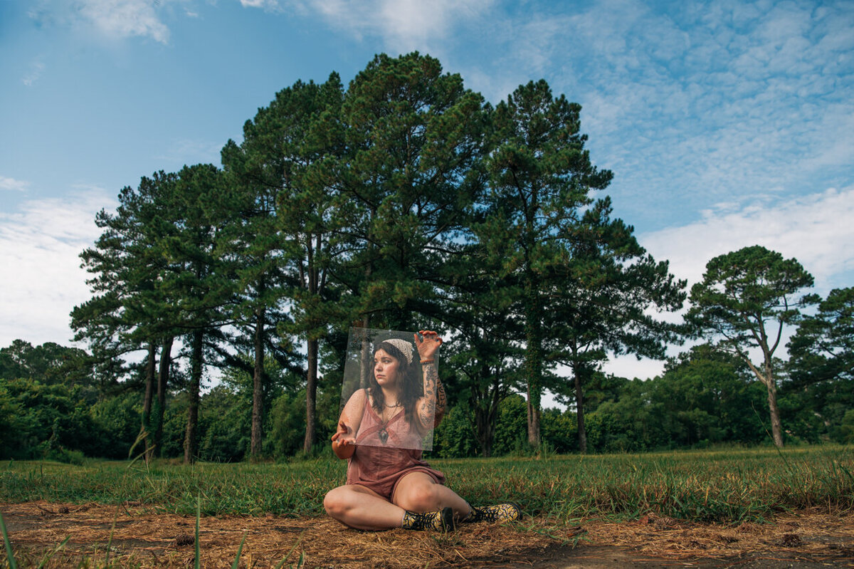 woman wearing a plastic dome and red leotard in the sun