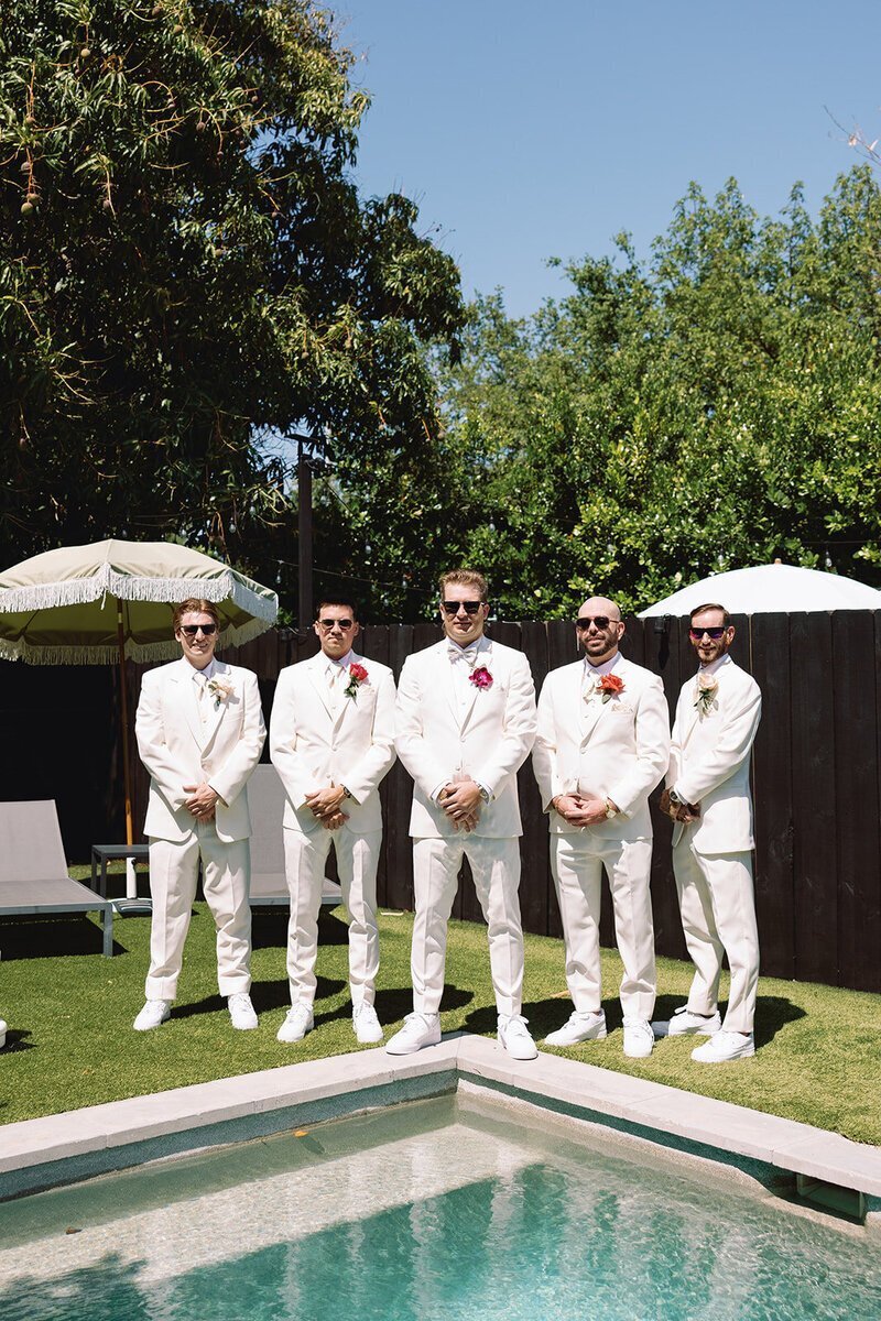 groomsmen posing at penthouse at riverside wharf wedding