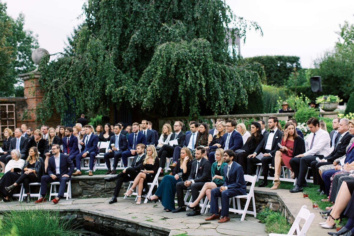 Guests seated around the pond for a luxury Chicago outdoor garden wedding.