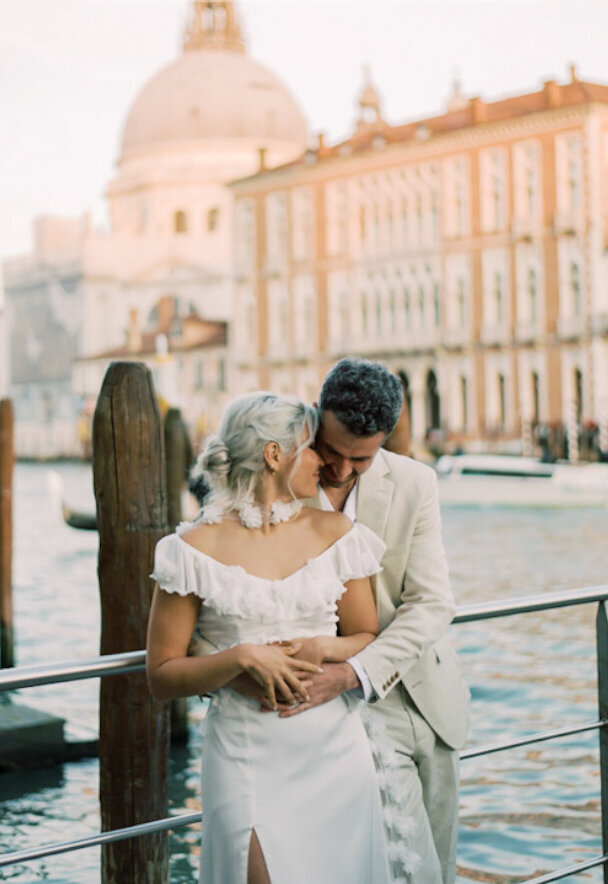 The couple sharing a quiet moment by the water, their love story beautifully captured in Venice by Christine Grace Photography