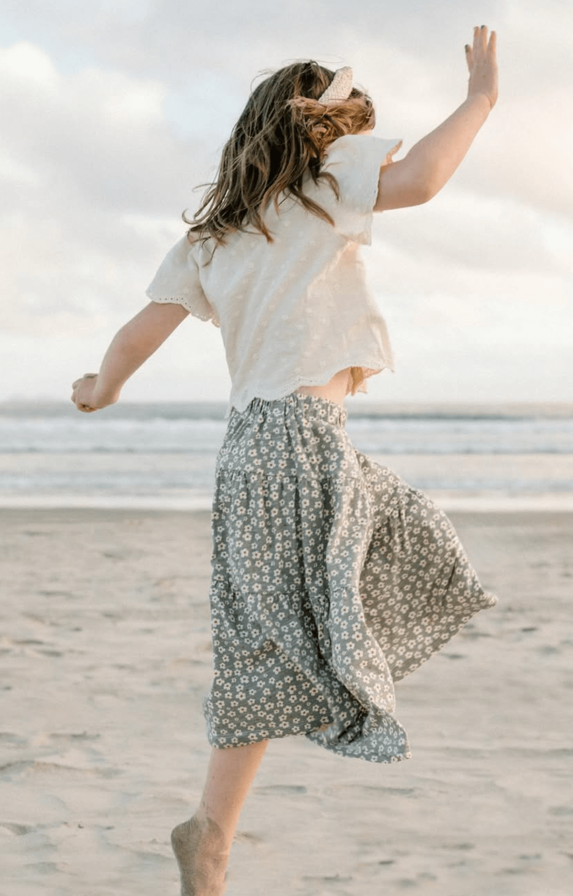Girl jumping in air at beach