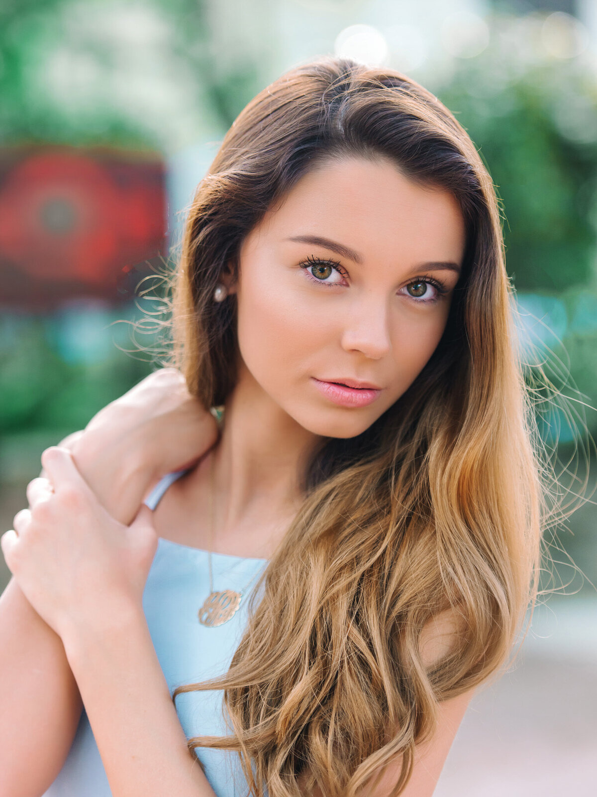 Strong expression senior close-up of teen girl in teal top taken in Charleston, South Carolina