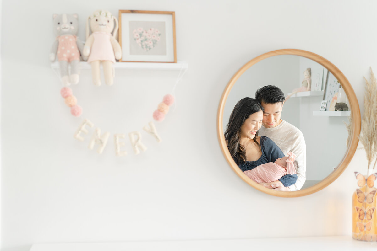 parents with newborn baby girl light and airy