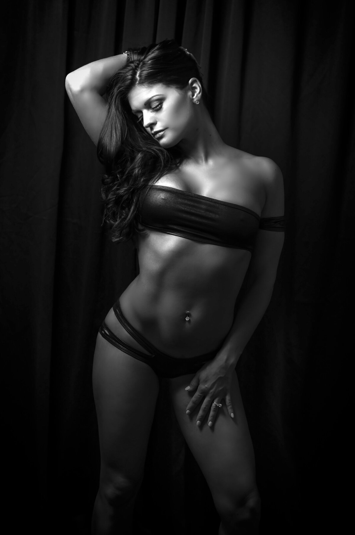 Woman posing in leather in black and white boudoir photo