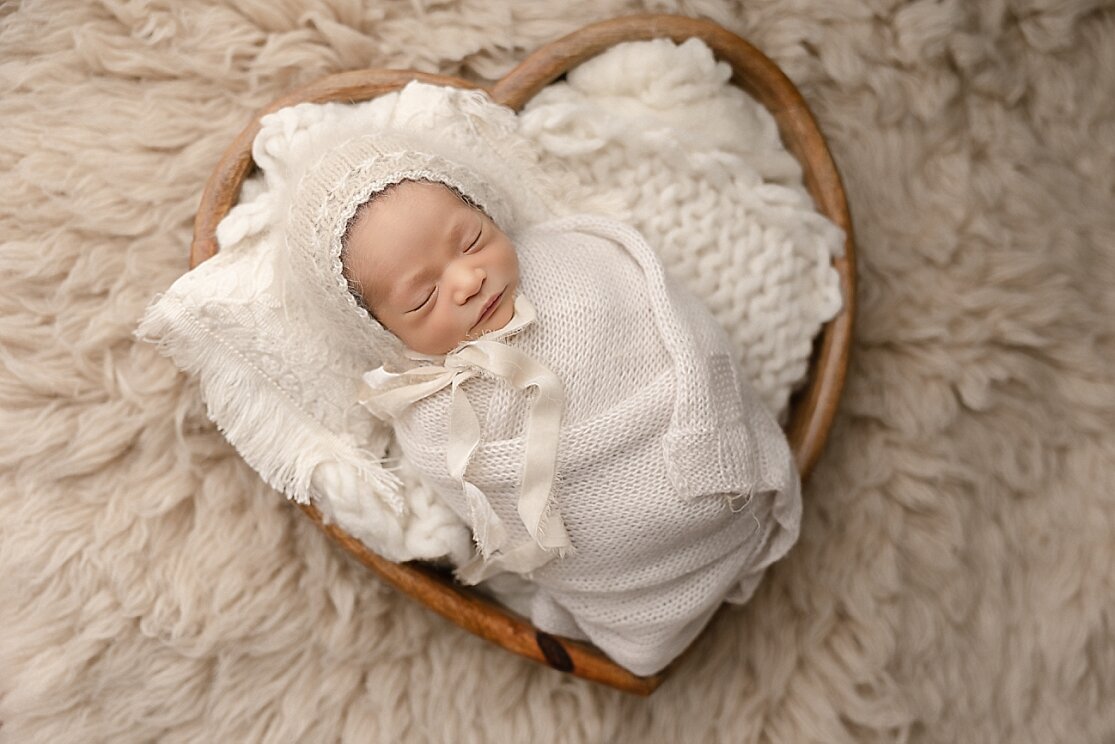baby girl in heart bowl by ann marshall photography