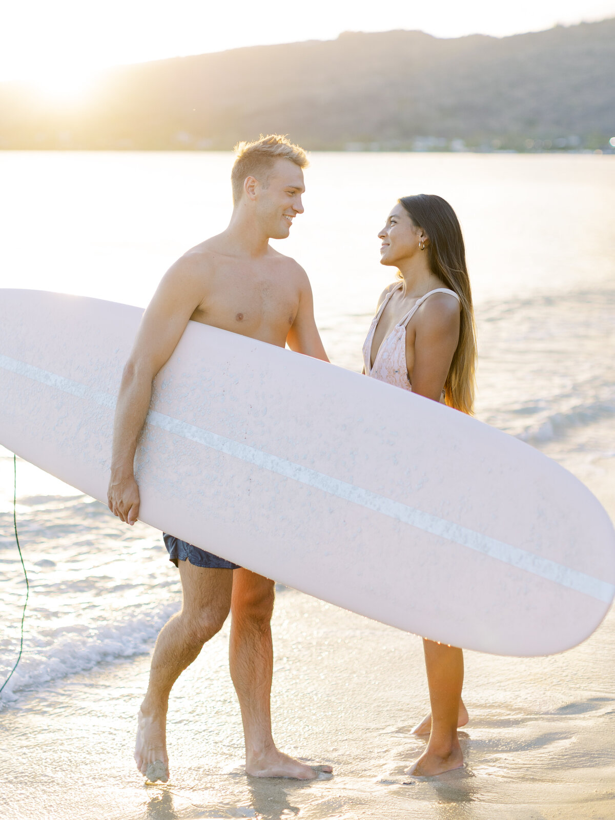 couple-on-beach-with-surfboard