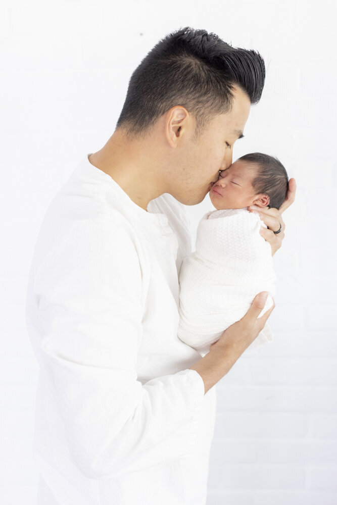 portrait of dad holding baby boy