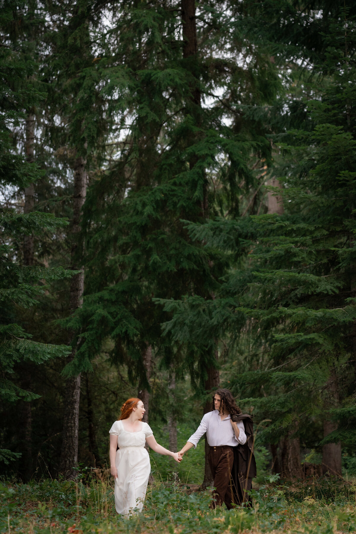 A couple holding hands and walking in a field