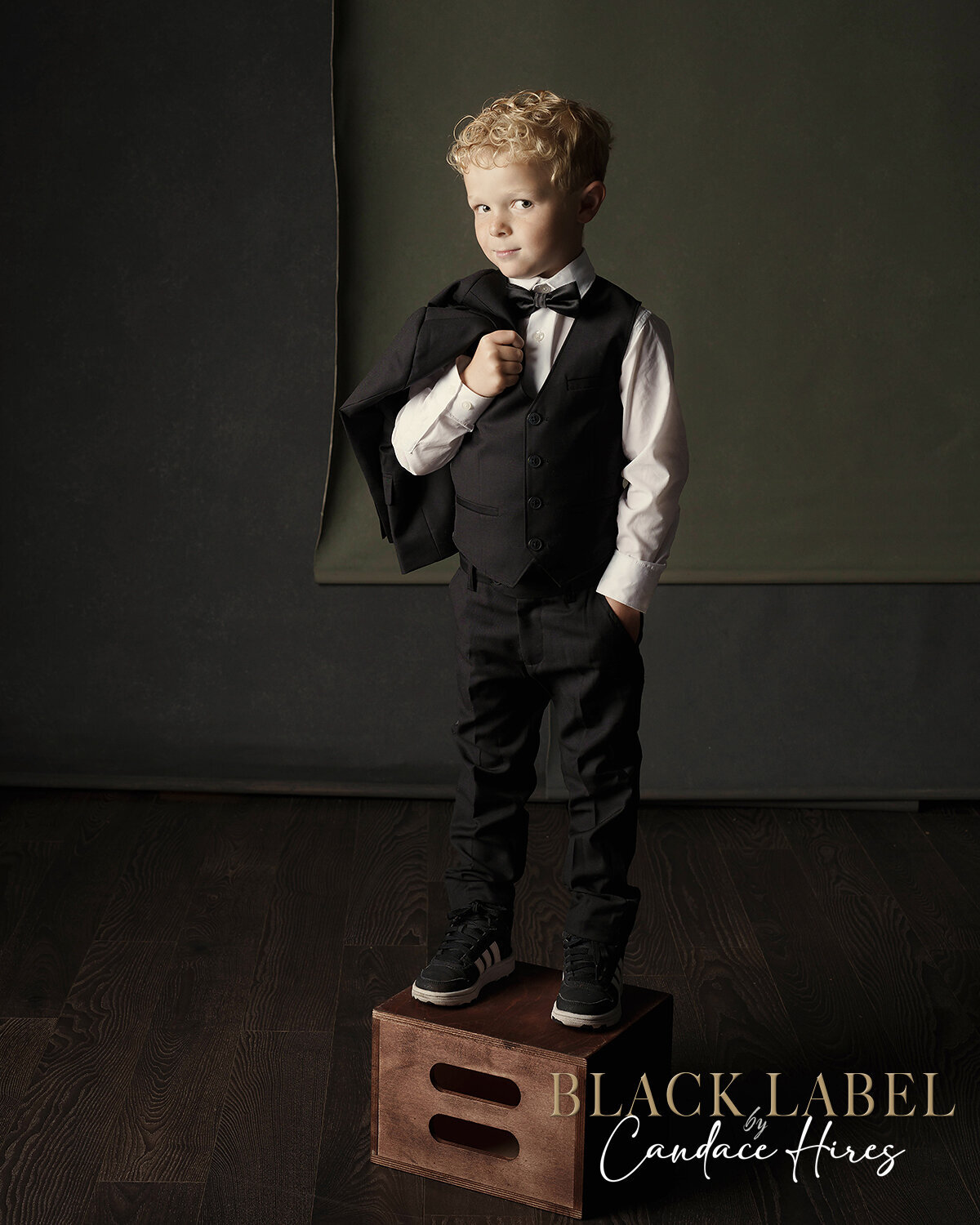 6 year old boy photographed in a tuxedo in a luxury setup in studio in ponte vedra