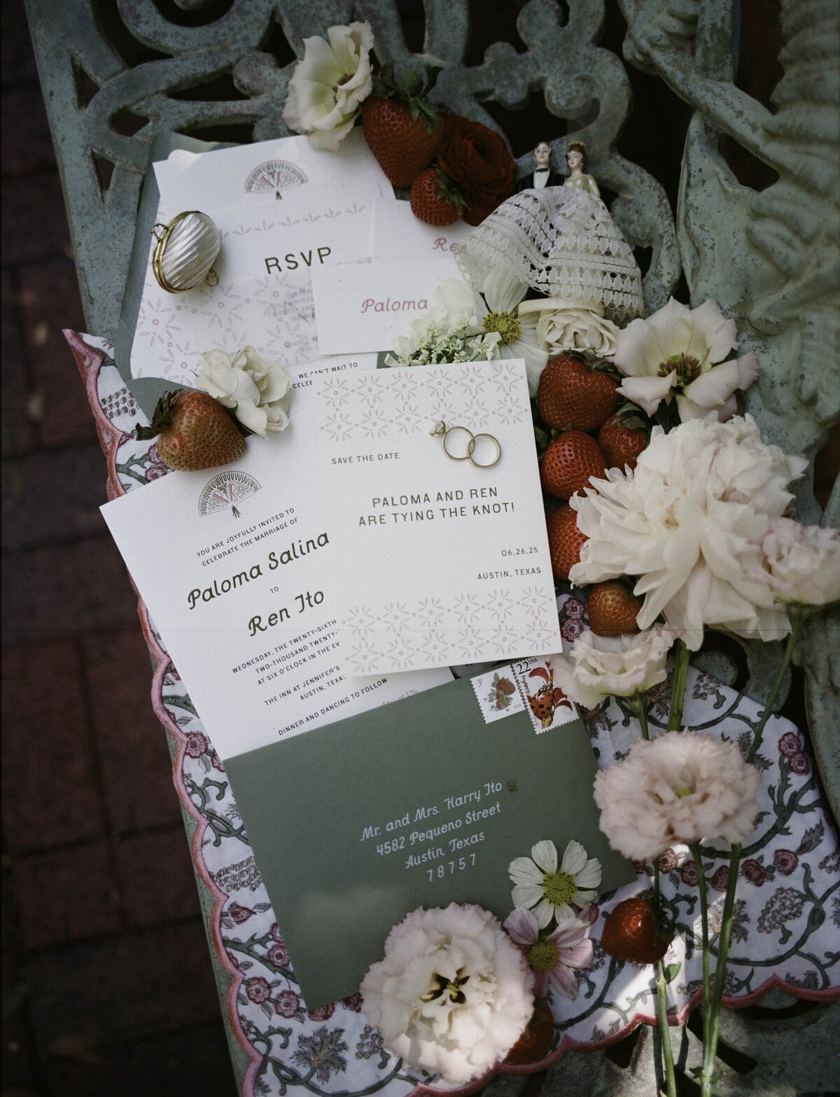 Custom invitation suite with invitation, RSVP card, and save the date card with green envelope with vintage stamps for a garden party wedding in Austin, Texas with pink and green custom illustrations and strawberries and vintage cake topper with wedding florals by Good Seed Floral photographed by Taylor Friedman Photo