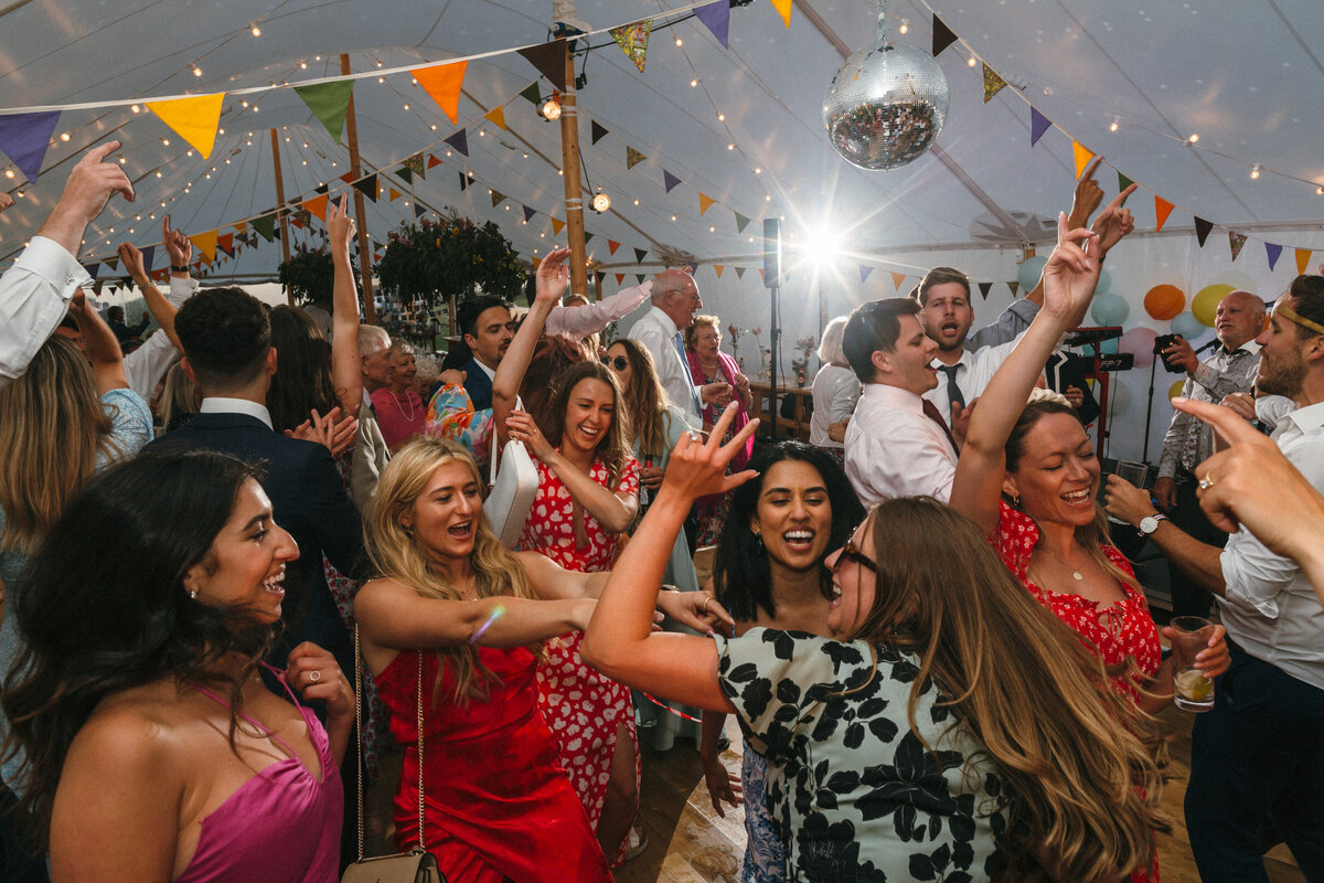Colourful dancefloor image at a wedding in a marquee