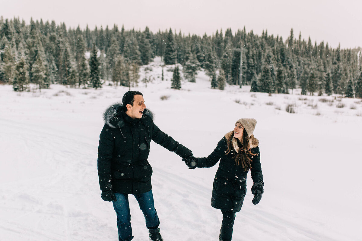 photo of couple playing in the sno