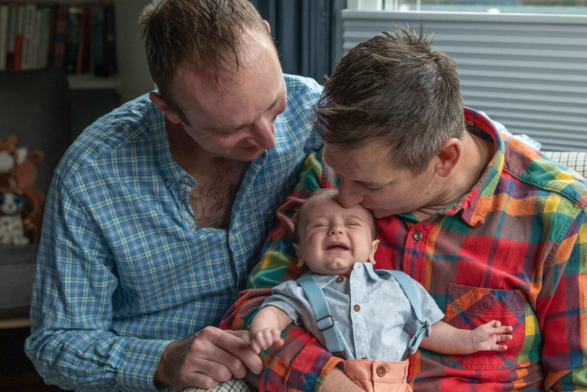 two-dads-crying-baby-family-photos
