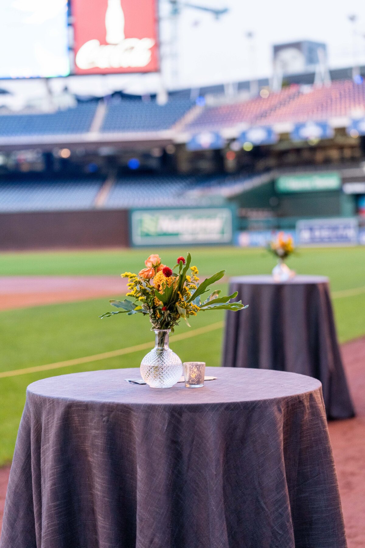 Table arrangements at a gala on a baseball field