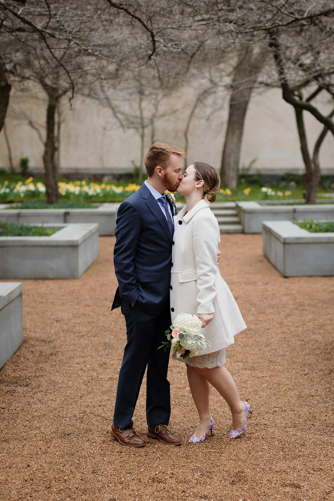 Just Married photo session couple kisses in springtime alley at Art Institute Chicago Garden