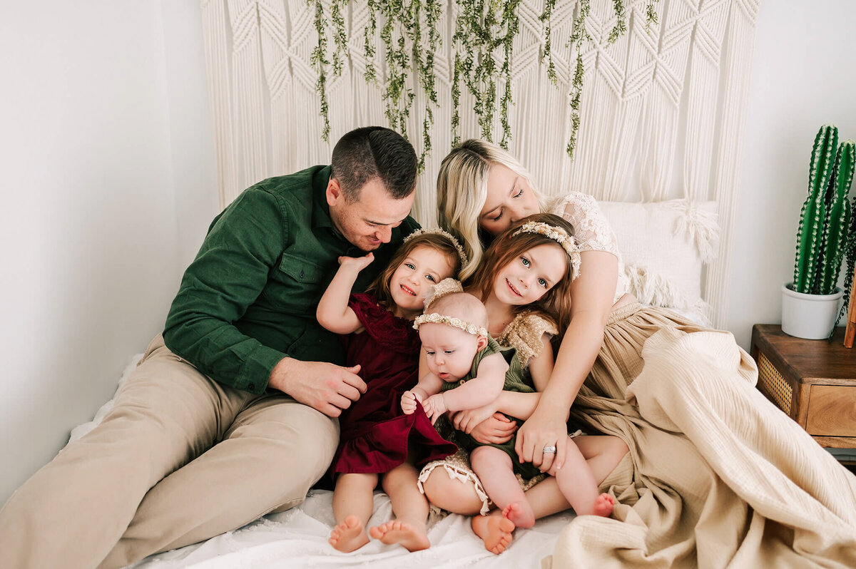 family cuddling in bed during Branson MO family photography studio