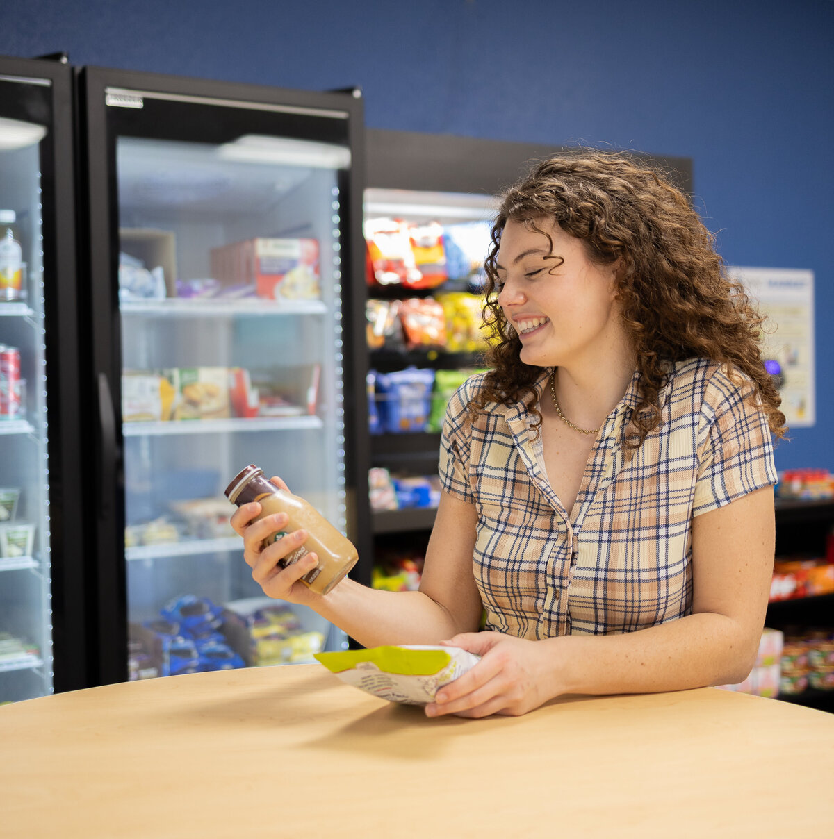 Employee in break room getting a snack from a vending machine at a micro market in Clearwater.
