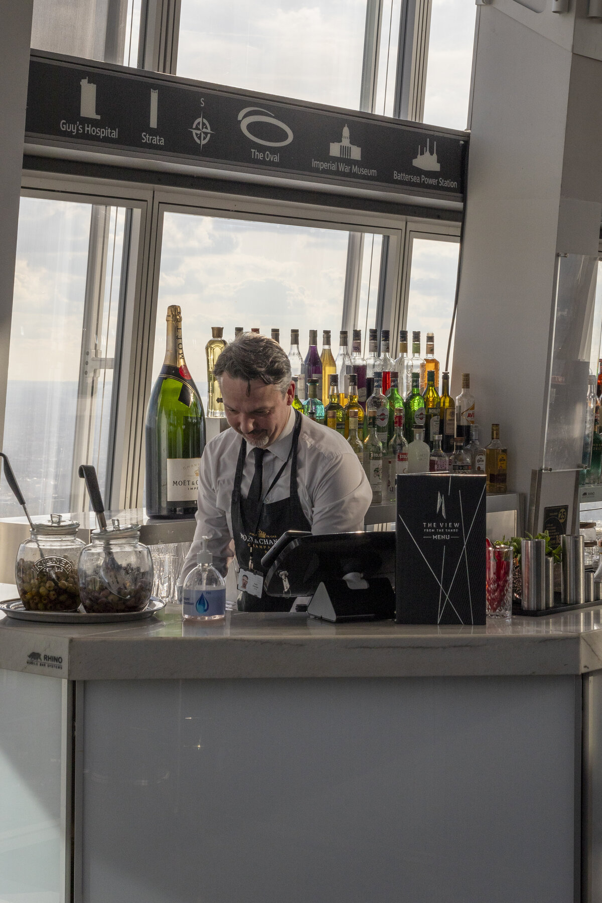 A bartender at the Shard pictured prepping mixers for a cocktail.