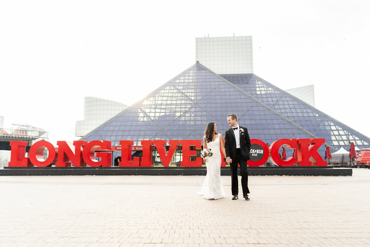 couples wedding portrait in front of Rock and Roll Hall of Fame in Cleveland