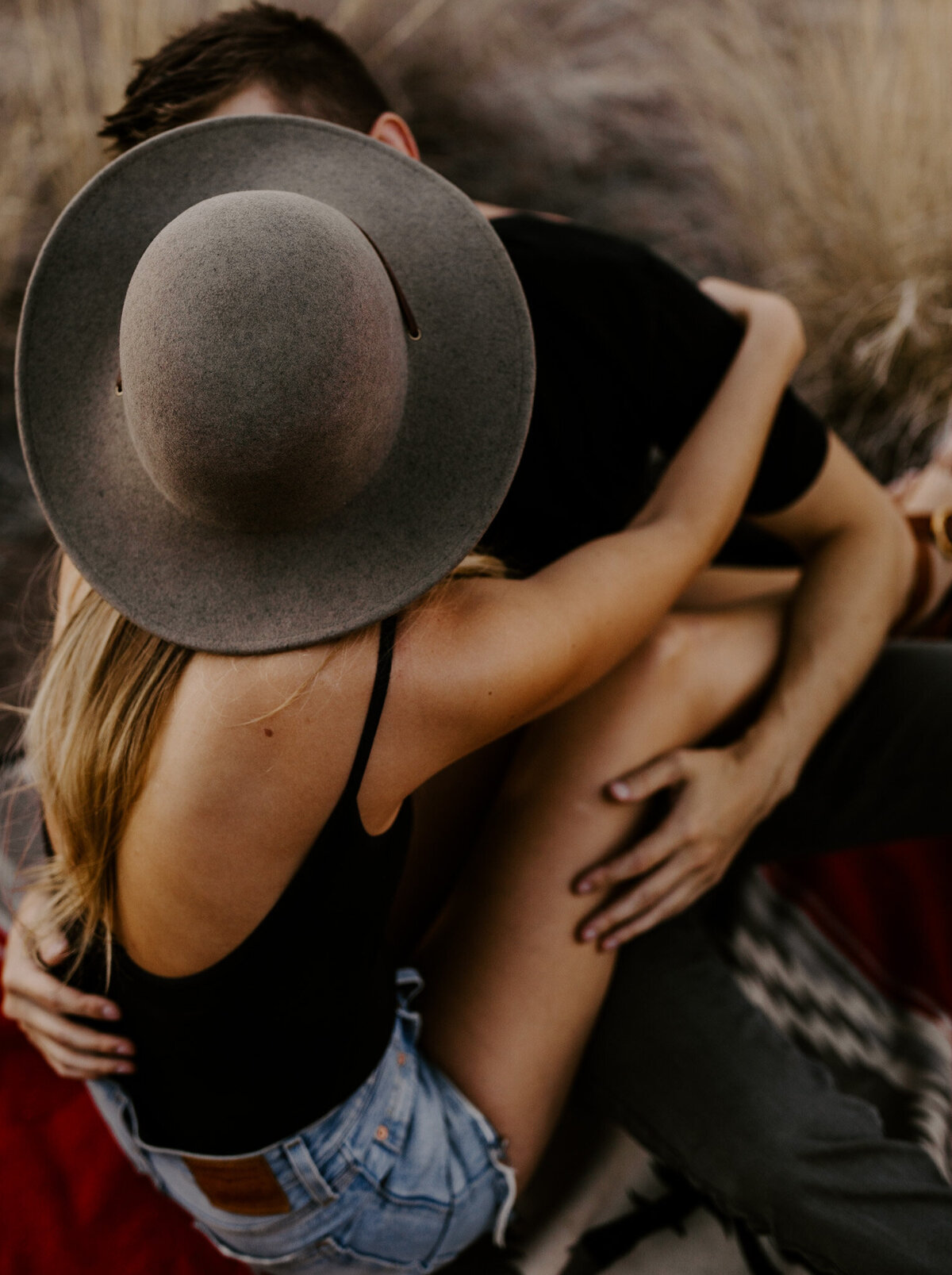 Couple cuddles under smith rock for a couples photography session