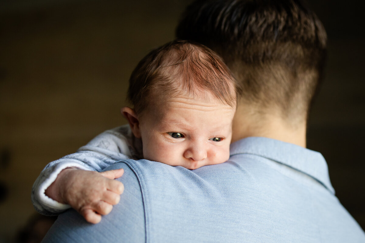 Baby laying on dad's shoulder