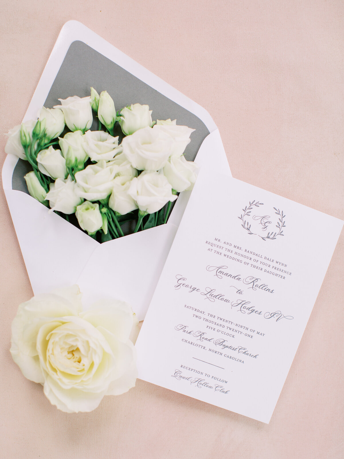 Quail Hollow Club wedding invitation flat lay with fresh flowers