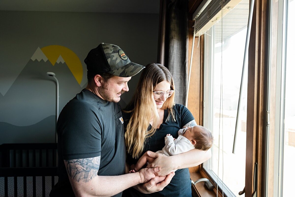 newborn baby in room with parents