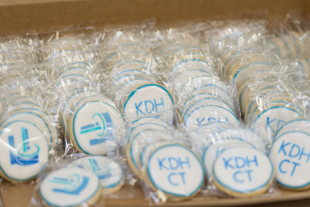 Ottawa event photography showing closeups of cookies with the KDH CT logo given to attendees during the ribbon cutting of the suite.  Captured by JEMMAN Photography COMMERCIAL