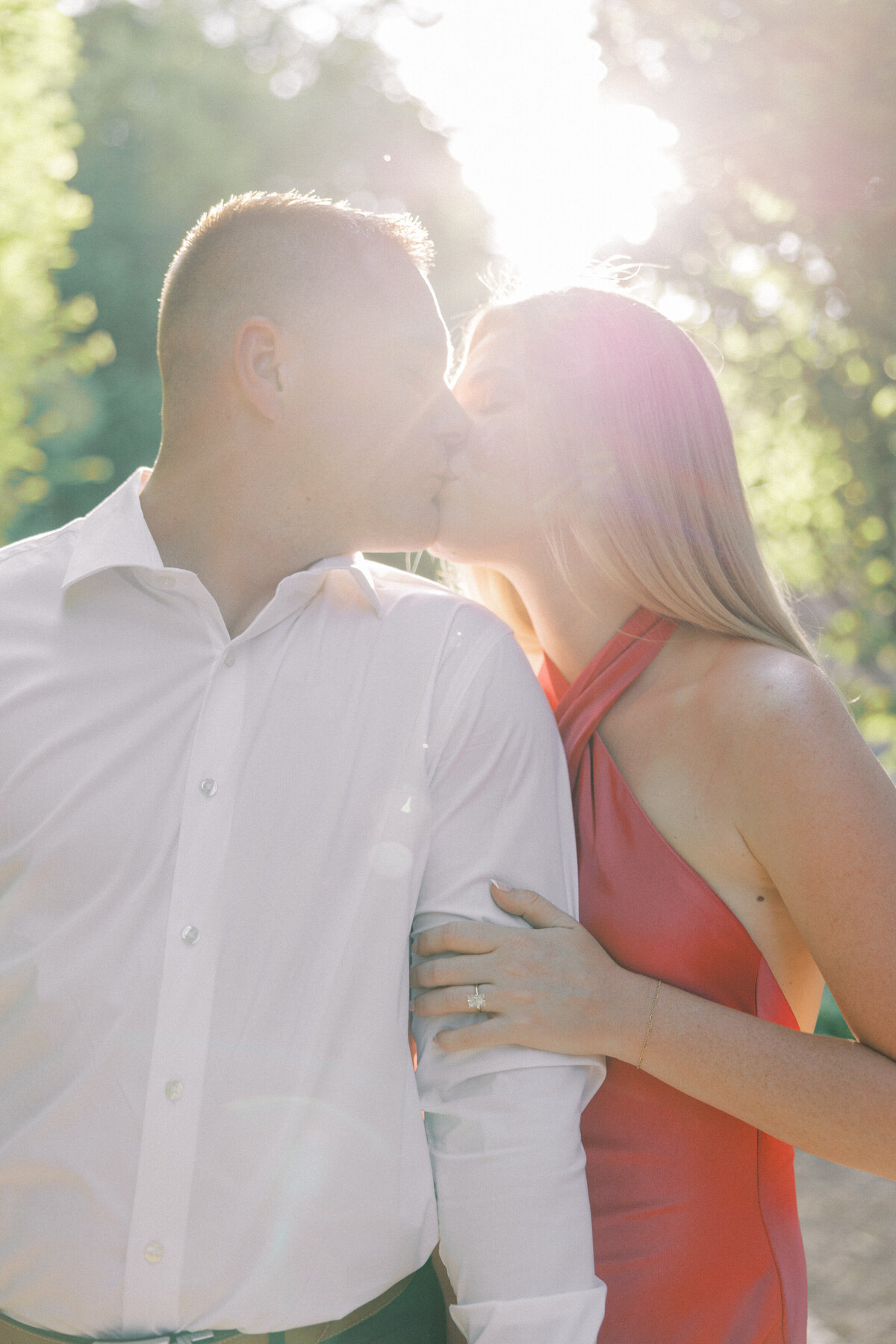 Close-up of engaged couple kissing in sunny Columbus session by Philadelphia photographer.